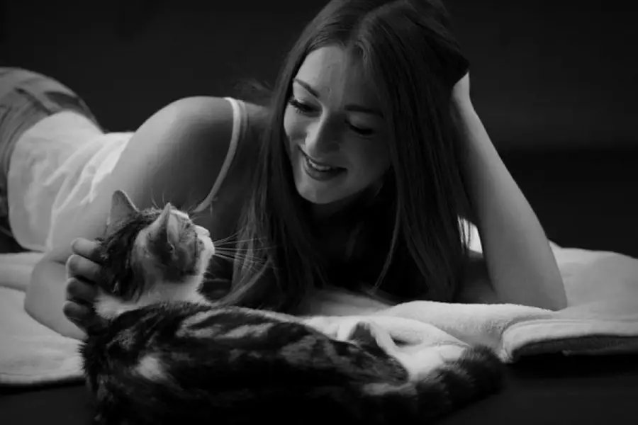 cat providing emotional support to a woman