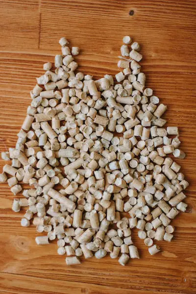 Biofuel - small wooden pellets over the wooden table
