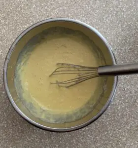 cake batter being mixed by whisk