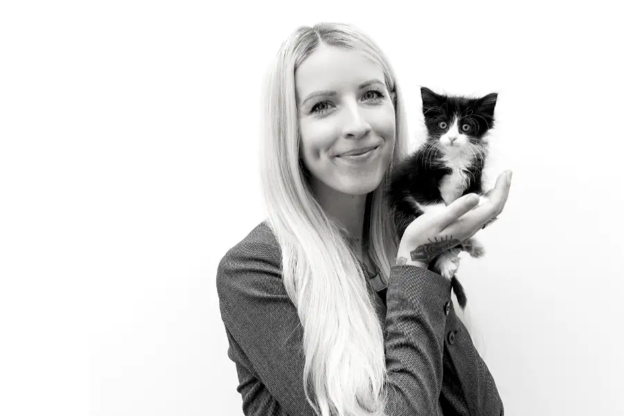 Hannah Shaw, "The Kitten Lady" with tiny black and white kitten