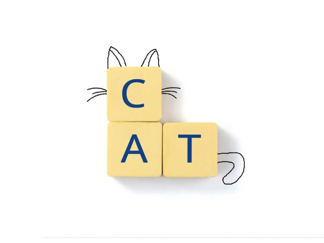 the word cat spelled out in scrabble tiles and styled to resemble a cat with cat ears, whiskers and a tail